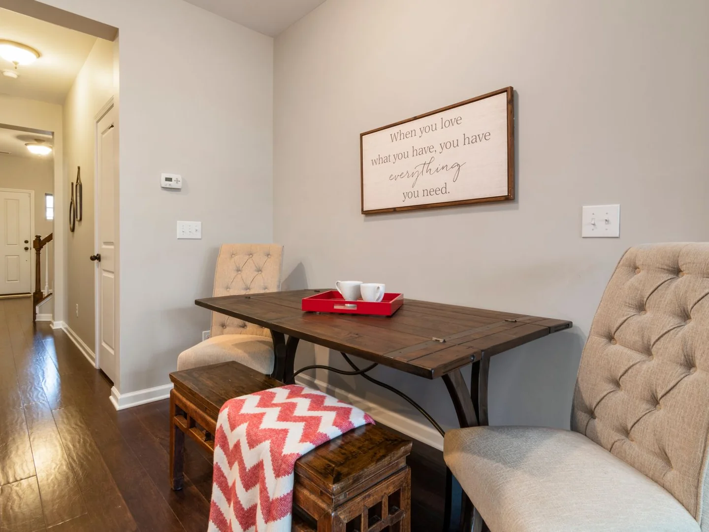 A dining table with a bench and upholstered chairs.