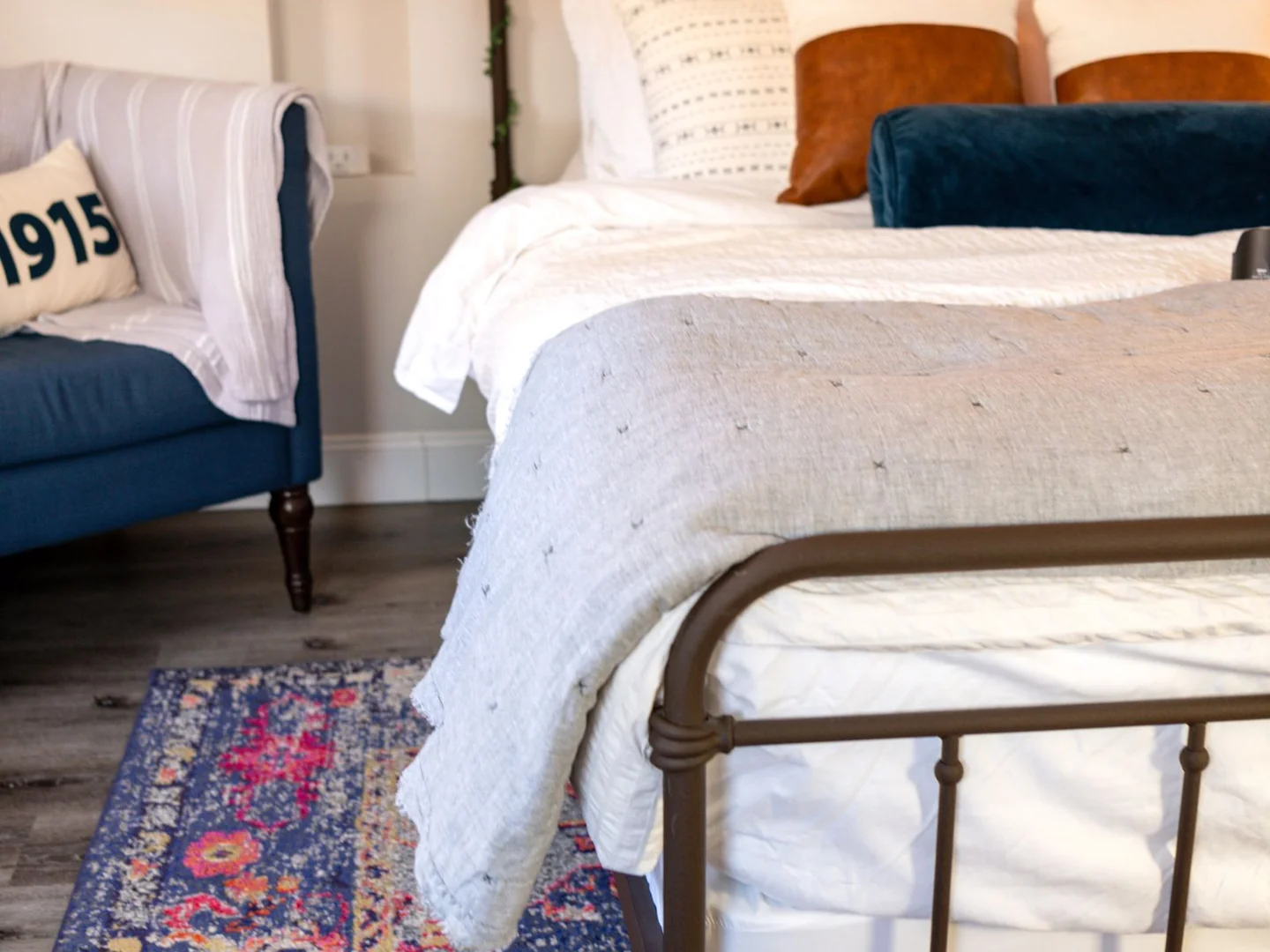 Blue and white bedding in a room with pale walls.