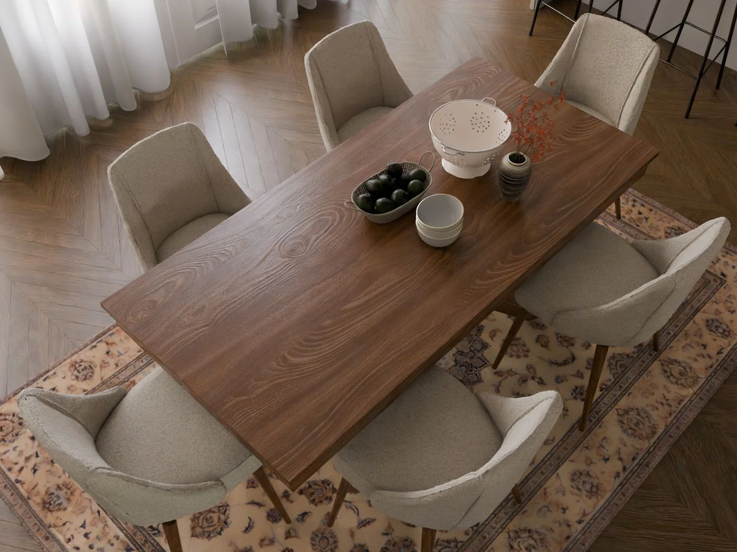 A dining table and chairs standing on a patterned rectangular rug.