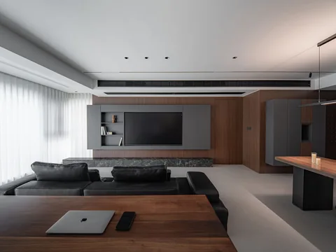 A long desk along one side of a living room.