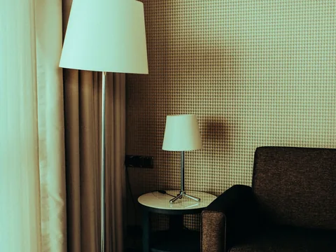 A floor lamp and a smaller table lamp beside seating.