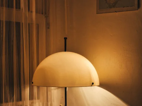 A glowing dome lamp casting warm light onto a room corner.
