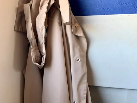 A coat hanging on a wall hook.