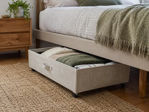 A low wheeled storage box pulled from under a bed.