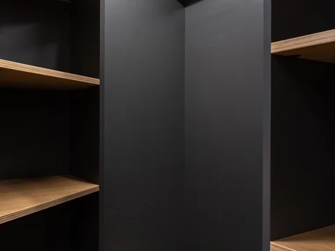 The shelves and compartments of a built-in wardrobe.