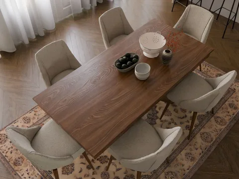 A dining table and chairs standing on a patterned rectangular rug.