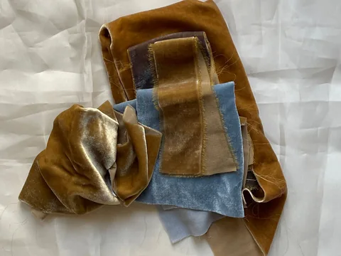 Folded velvet swatches catching daylight at different angles.